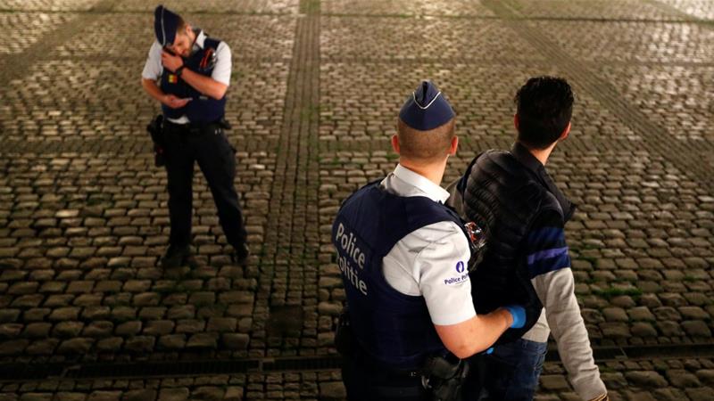 Police officers on patrol search a man during the lockdown imposed by the Belgian government to slow down the spread of Covid 19 in Brussels Belgium on April 17 2020