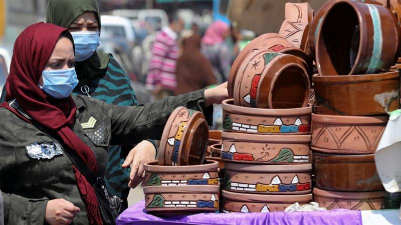 Women shop at a market wearing protective face masks amid concerns over COVID 19 in Cairo Egypt on April 12 2020